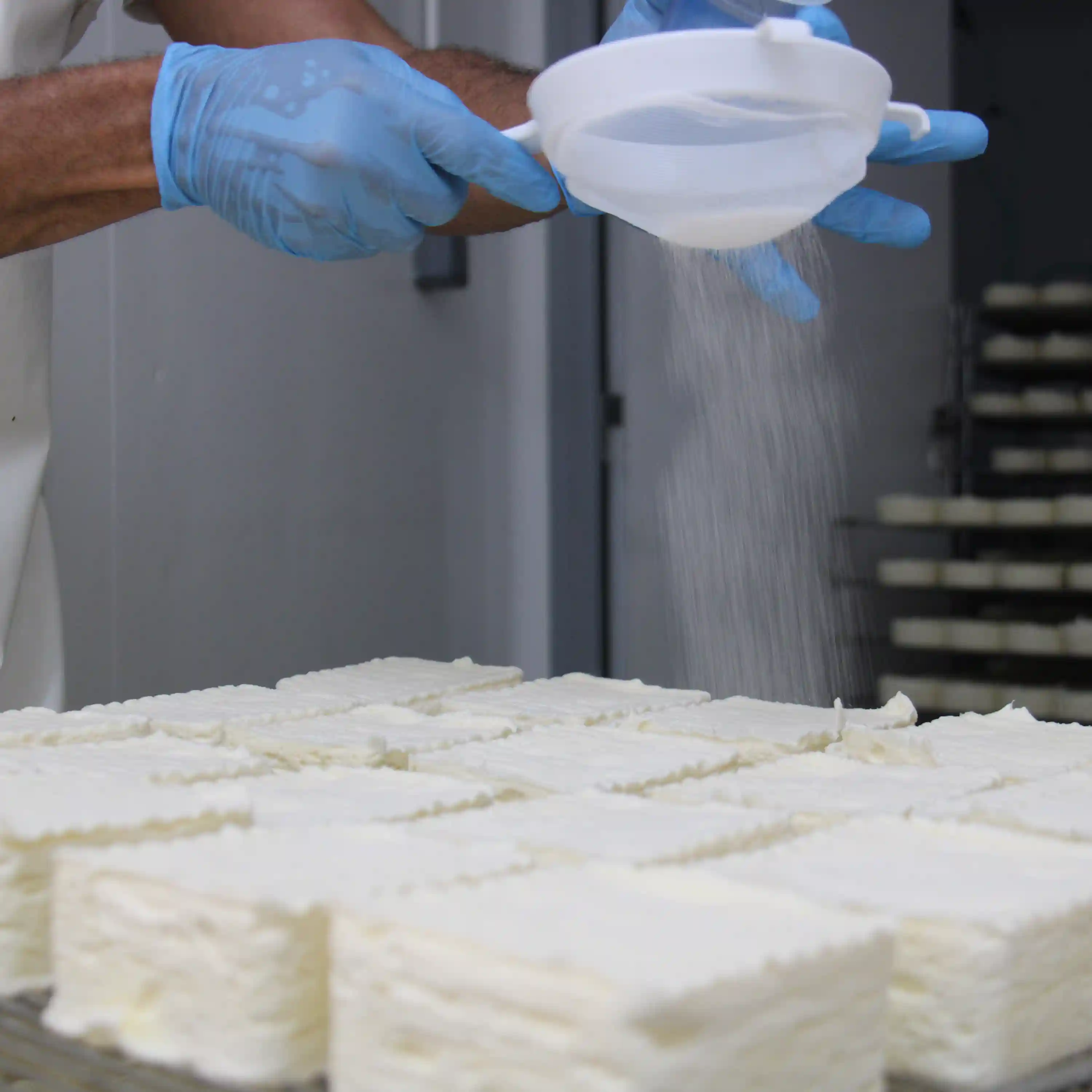 Photo d'un fromager formant les Neufchâtel en cœur.
